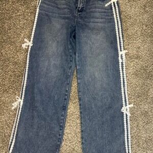 Tenthirty navy blue jeans with white stitching and bow detail. Size: 9